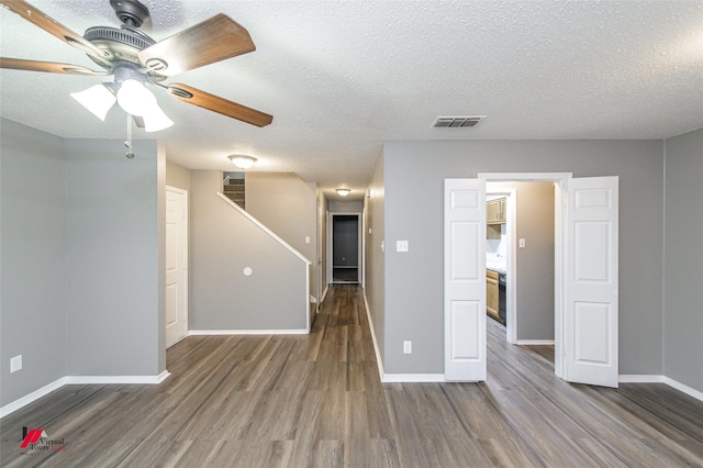 spare room featuring ceiling fan, a textured ceiling, and dark hardwood / wood-style floors