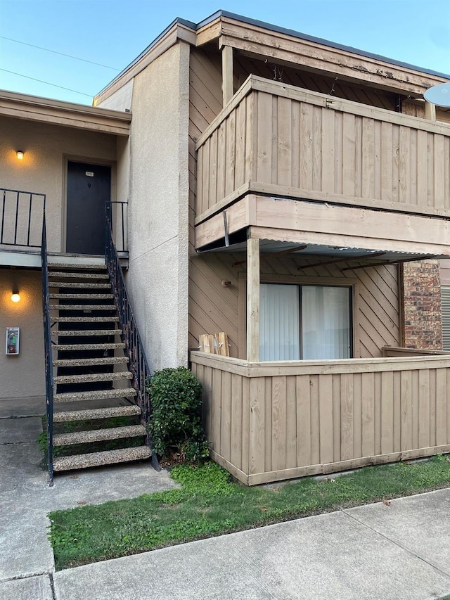 view of side of home featuring a balcony