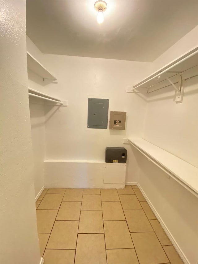 walk in closet featuring light tile patterned floors and electric panel