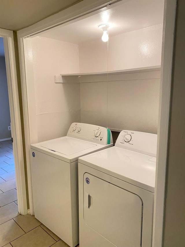 laundry area featuring light tile patterned flooring and washing machine and clothes dryer