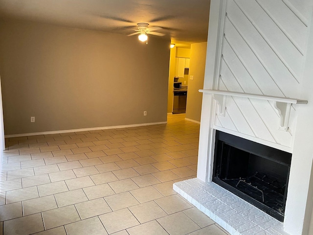 unfurnished living room featuring ceiling fan and light tile patterned floors