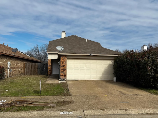 view of front facade featuring a garage and a front lawn