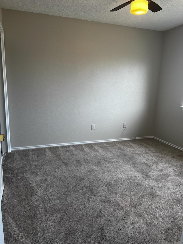 unfurnished room featuring ceiling fan, a textured ceiling, and dark colored carpet