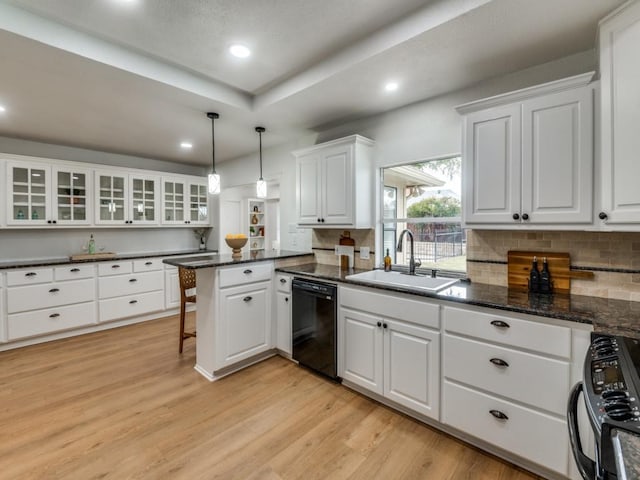 kitchen featuring black appliances, decorative light fixtures, and white cabinetry