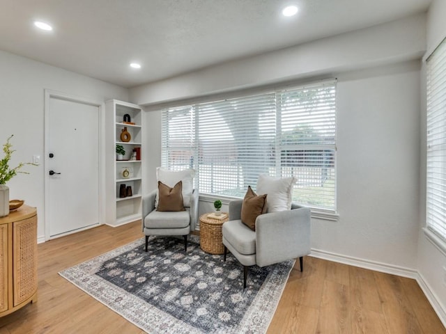 sitting room with hardwood / wood-style flooring