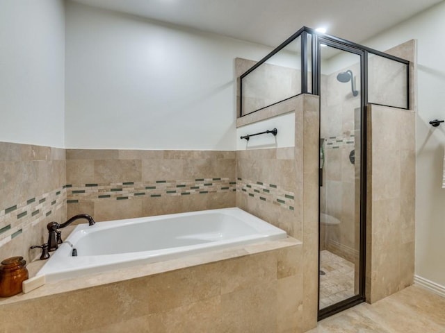 bathroom featuring independent shower and bath