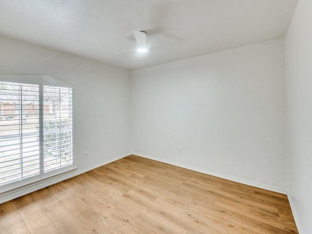 spare room with ceiling fan and light wood-type flooring