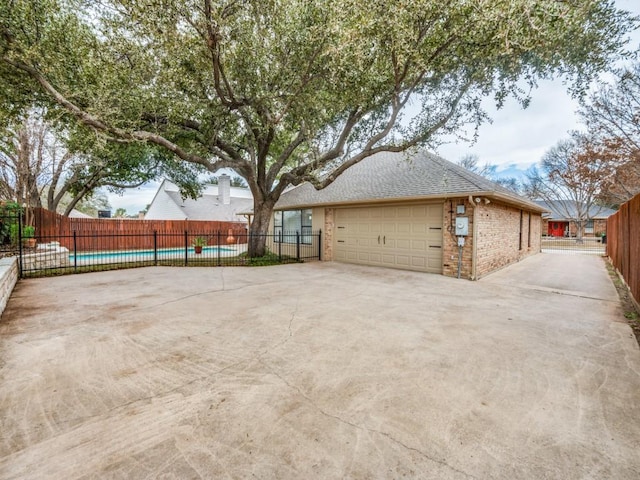 view of side of home with a garage and a swimming pool