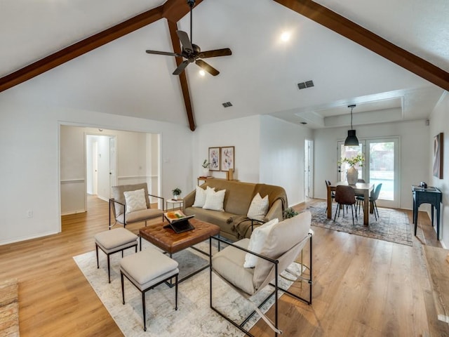 living room with ceiling fan, light hardwood / wood-style floors, high vaulted ceiling, and beamed ceiling