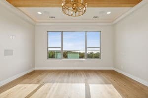 unfurnished room with hardwood / wood-style flooring and an inviting chandelier