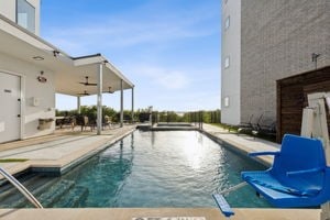 view of swimming pool with ceiling fan and a patio