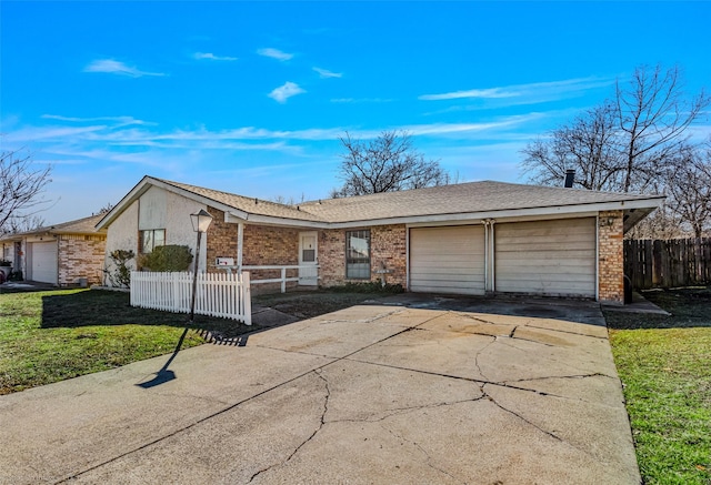 ranch-style home featuring a garage and a front yard