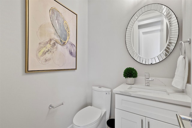 bathroom with toilet and vanity