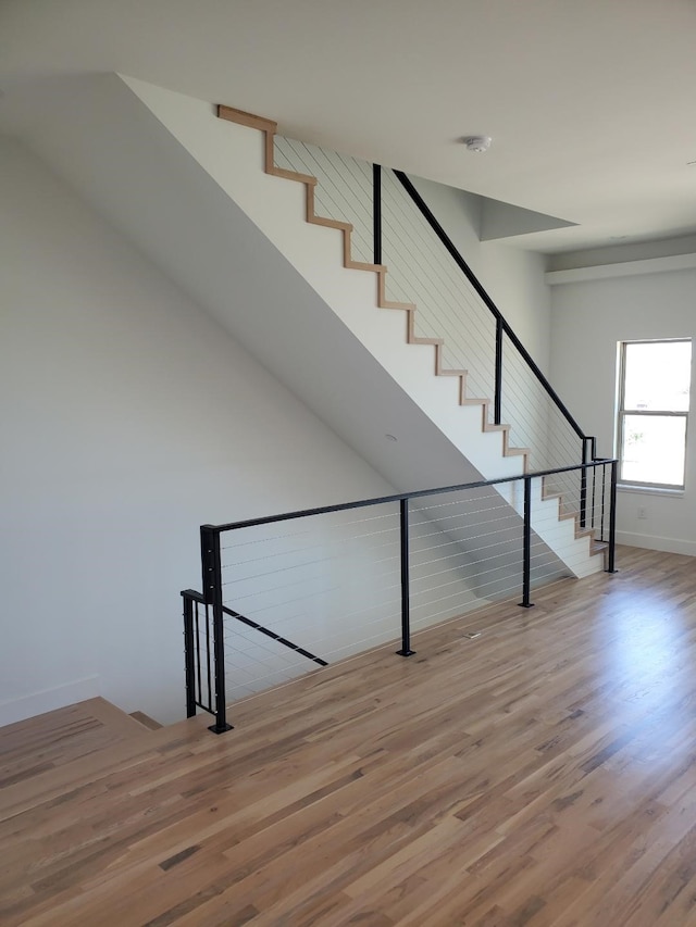 stairs featuring hardwood / wood-style floors