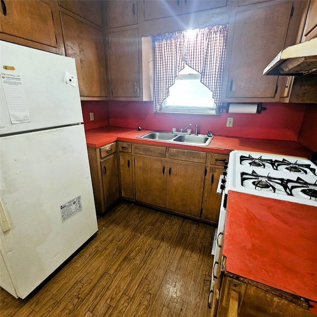 kitchen with dark hardwood / wood-style flooring, sink, and white appliances