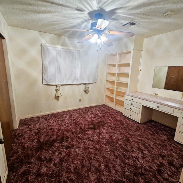 unfurnished bedroom featuring ceiling fan, a textured ceiling, and carpet flooring