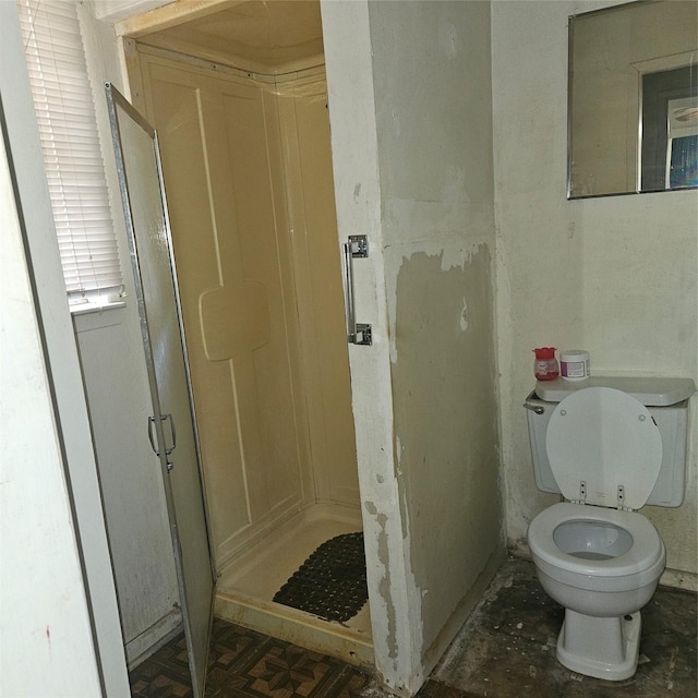 bathroom with toilet and walk in shower