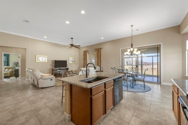 kitchen featuring ceiling fan with notable chandelier, decorative light fixtures, black dishwasher, an island with sink, and sink