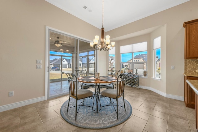 tiled dining area with ceiling fan with notable chandelier