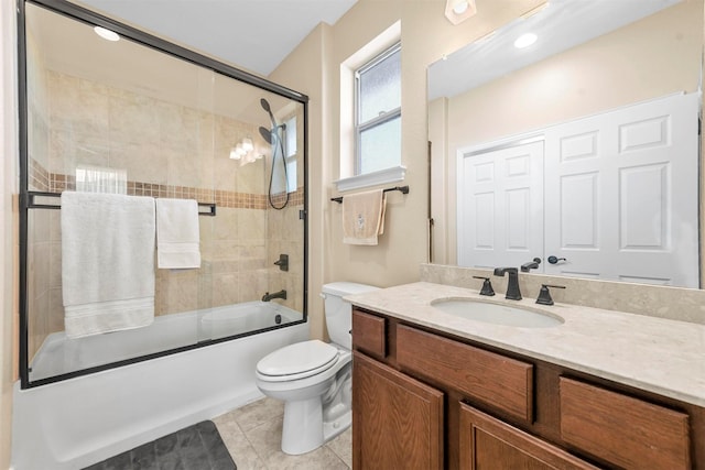 full bathroom with toilet, tile patterned floors, vanity, and shower / bath combination with glass door