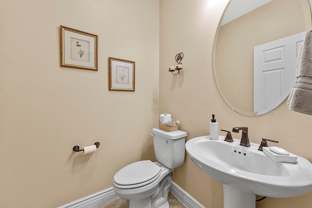 bathroom featuring toilet and sink