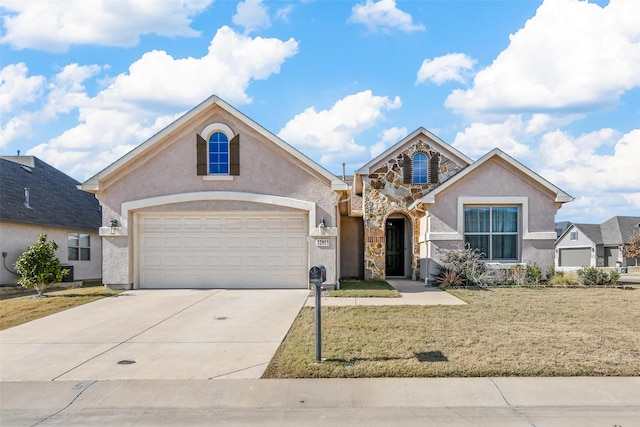 view of property featuring a front yard and a garage