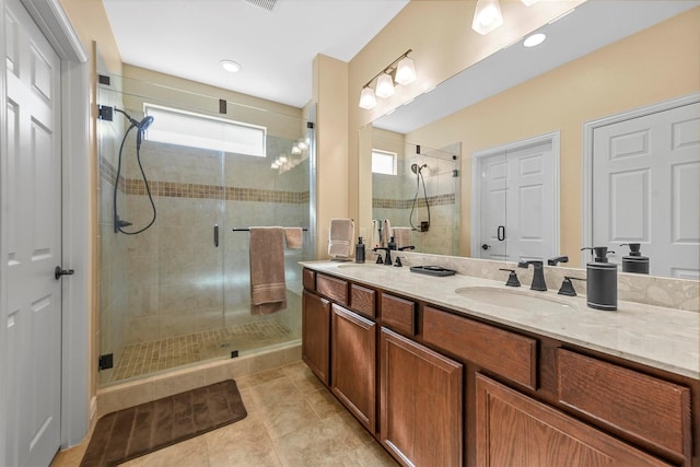 bathroom with tile patterned floors, a shower with shower door, and vanity