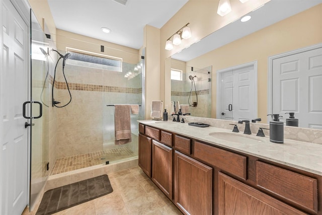 bathroom featuring an enclosed shower, vanity, and tile patterned flooring