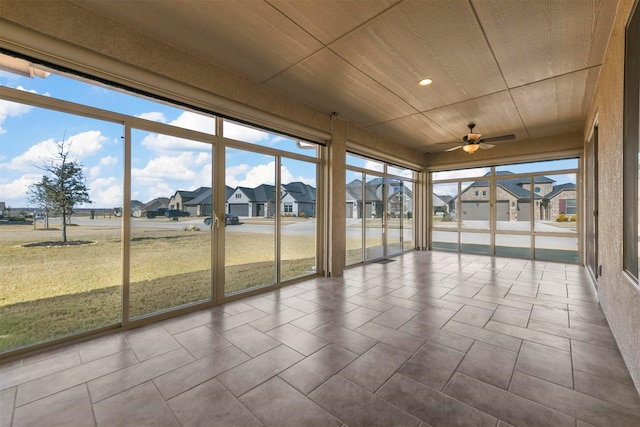 unfurnished sunroom with ceiling fan and wood ceiling