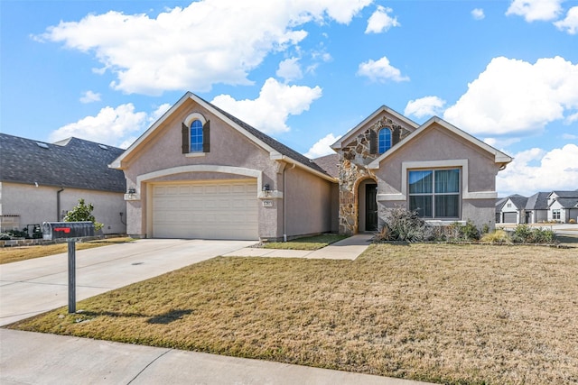 view of front of property with a front yard and a garage