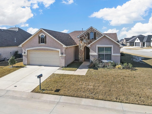 view of front of property featuring a garage and a front yard