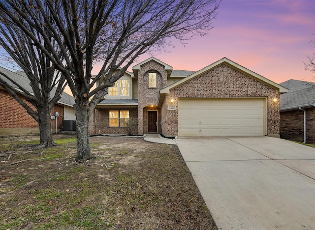 view of front of house with a garage and central AC