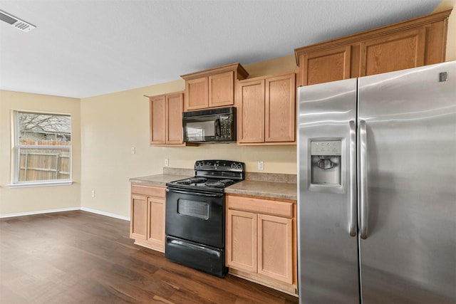 kitchen with black appliances, light brown cabinetry, and dark hardwood / wood-style floors