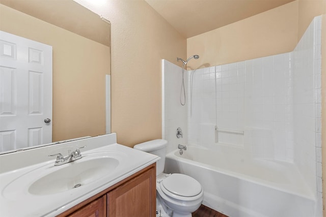 full bathroom featuring toilet, vanity, and  shower combination