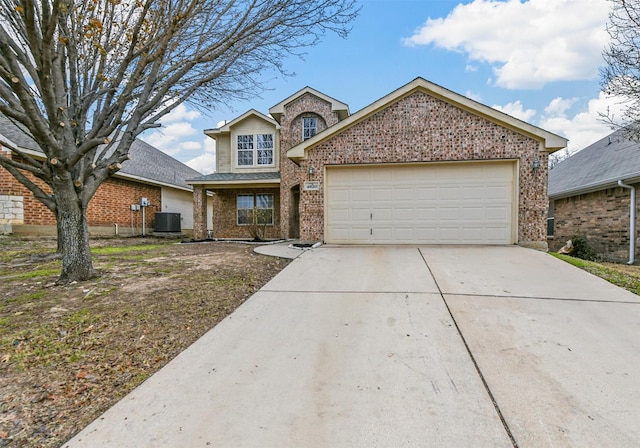 view of front property with a garage and central AC