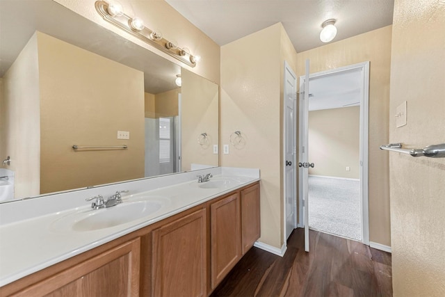 bathroom with vanity and hardwood / wood-style flooring