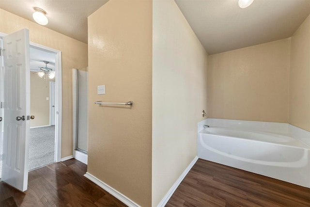 bathroom with hardwood / wood-style floors and independent shower and bath