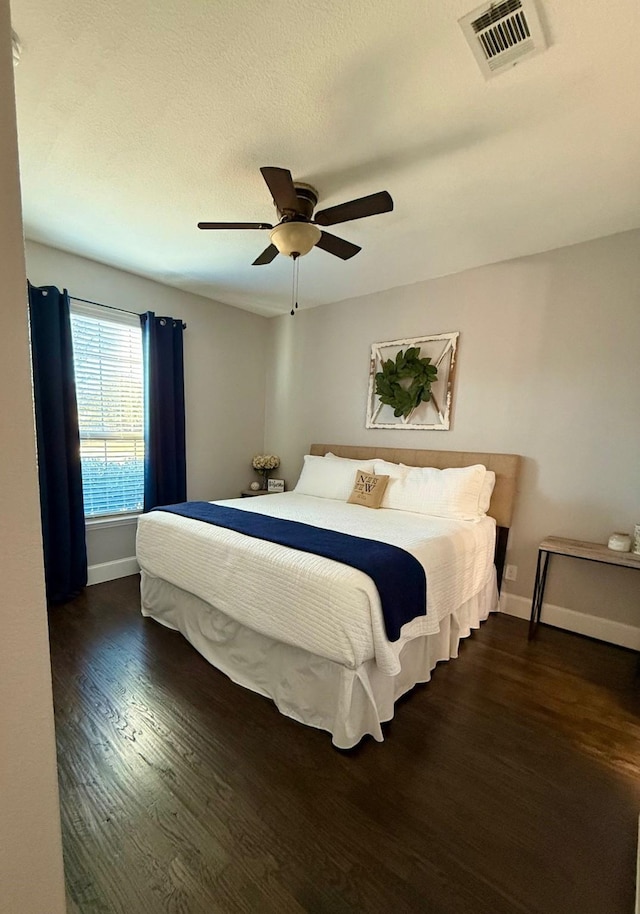 bedroom with dark wood-type flooring and ceiling fan