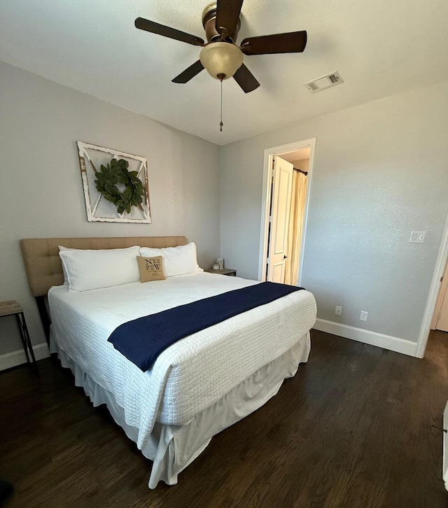 bedroom with ceiling fan and dark hardwood / wood-style floors