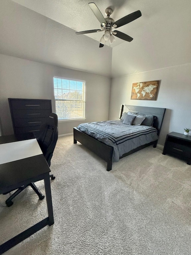 carpeted bedroom featuring ceiling fan, a textured ceiling, and lofted ceiling