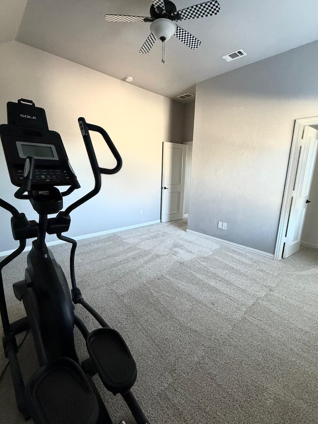 exercise area featuring vaulted ceiling and carpet flooring