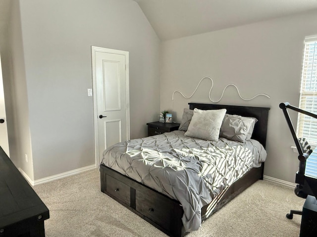 bedroom featuring light carpet and vaulted ceiling