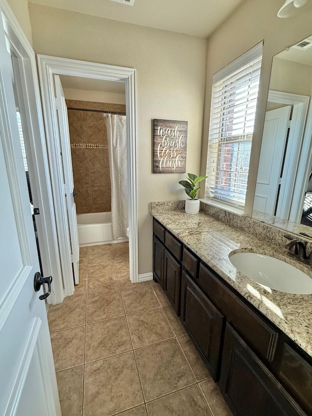 bathroom featuring tile patterned flooring, shower / bathtub combination with curtain, and vanity