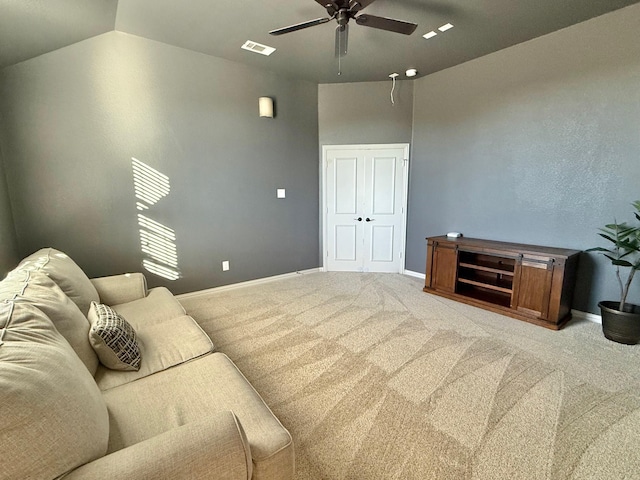 living room featuring ceiling fan, light carpet, and vaulted ceiling