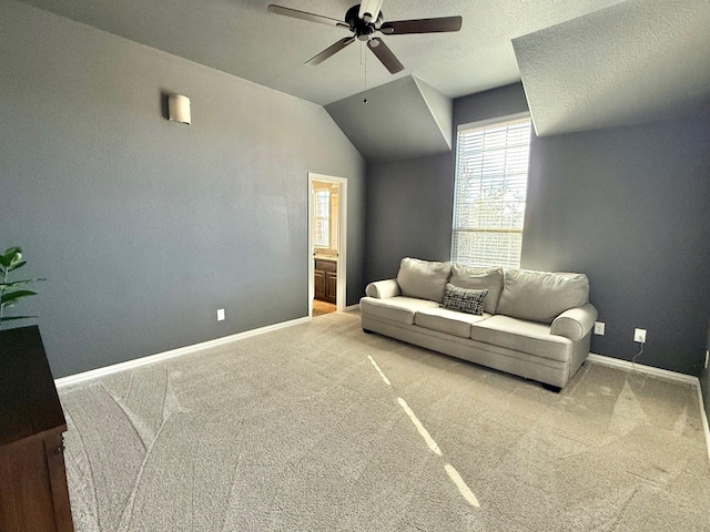 carpeted living room featuring ceiling fan and lofted ceiling