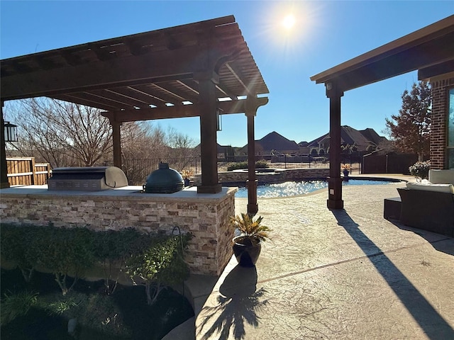 view of yard featuring exterior kitchen, a pergola, a patio, and a fenced in pool