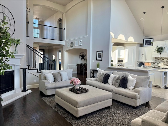 living room with dark hardwood / wood-style floors and a high ceiling