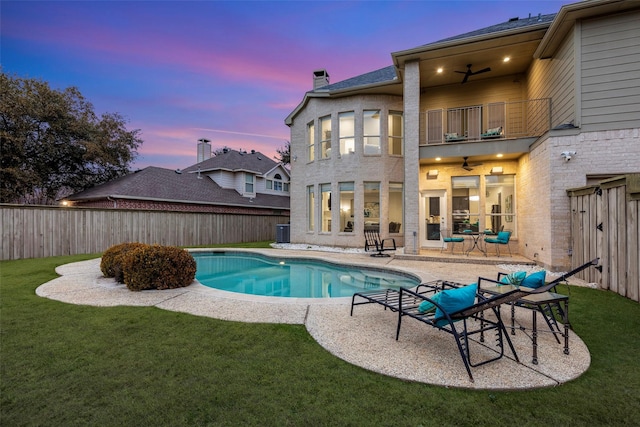 pool at dusk with a fenced in pool, a patio area, ceiling fan, cooling unit, and a fenced backyard