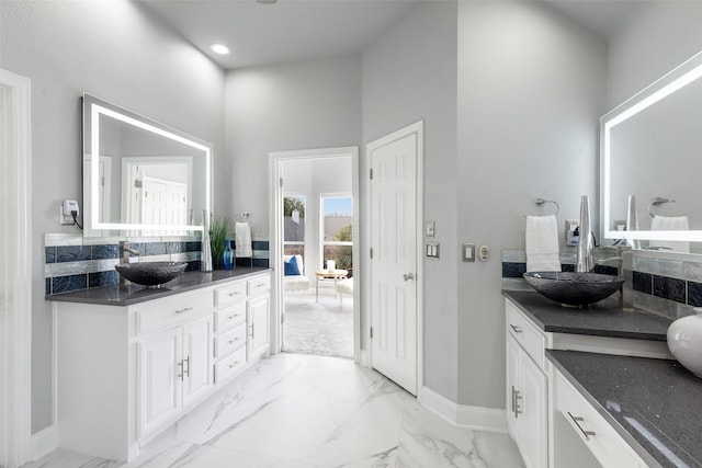 bathroom with recessed lighting, marble finish floor, vanity, and baseboards