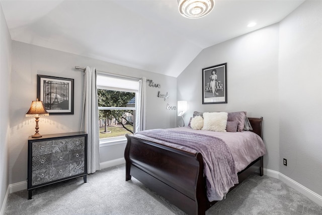 bedroom with baseboards, lofted ceiling, and carpet flooring